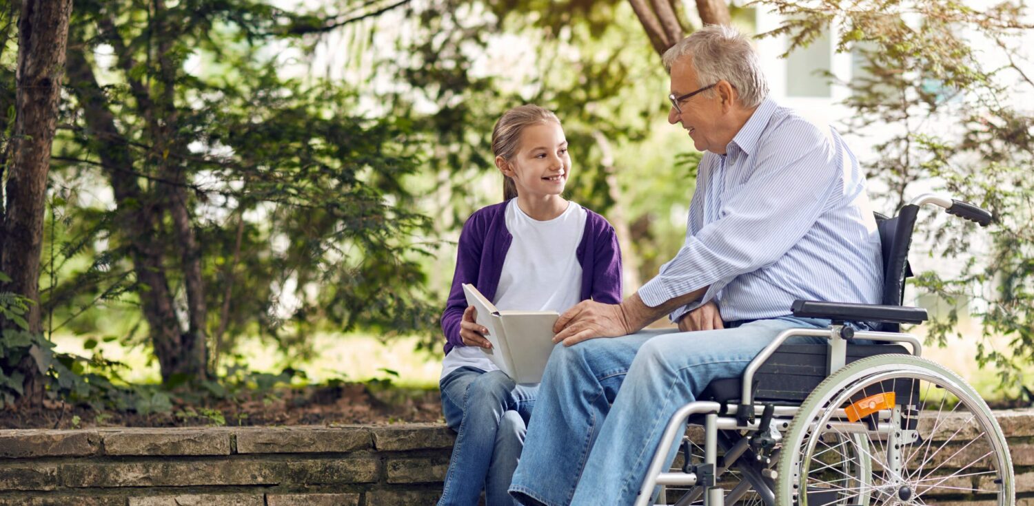 senior resident enjoying his time outdoors with his grandchild